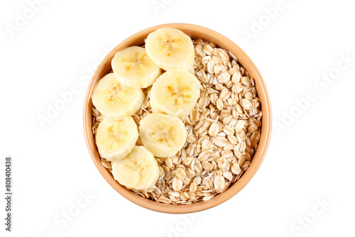 Raw organic oat flakes whit banana in ceramic bowl isolated on white background. Photography for packaging