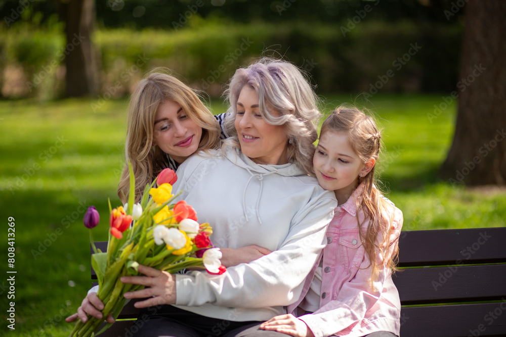 Three generations family with tulip bouquet Three generations family with tulip bouquet