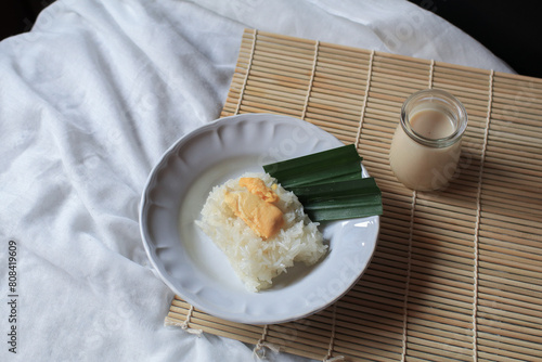 Sticky rice with durian in coconut milk. Asian Thai dessert summer tropical fruit food. Khao Nieow Nam Kati Durian photo