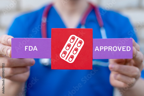 Doctor holding styrofoam blocks with drug icon sees inscription: FDA APPROVED. FDA Food and Drug Administration Department Service Healthcare concept.