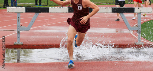 One runner running out of the water during a steeplechase race