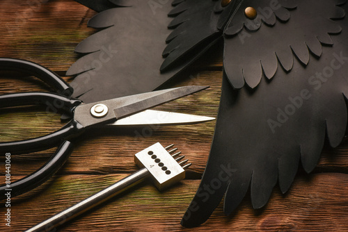 Leather craft work tools and leather on the tanner workbench concept background. photo