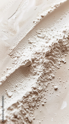 Close-up of textured beige powder on neutral background