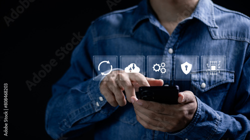 Software update or operating system upgrades to keep your device up to date with enhanced functionality in new versions and improved security. Man using smartphone to install software update.