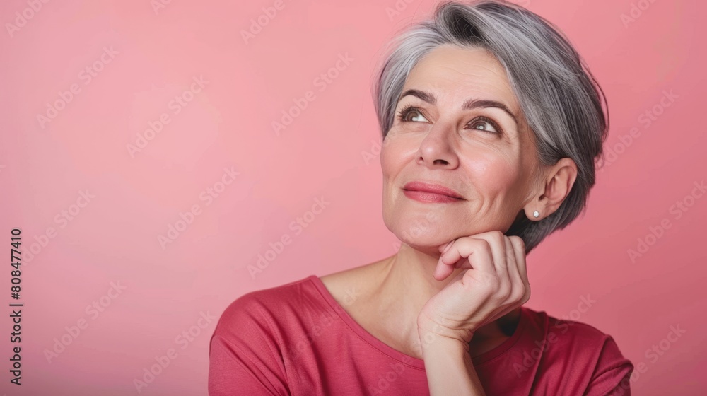Optimistic Senior Woman Smiling Thoughtfully in Pink Shirt. Optimistic Senior Woman Smiling Thoughtfully in Pink Shirt.