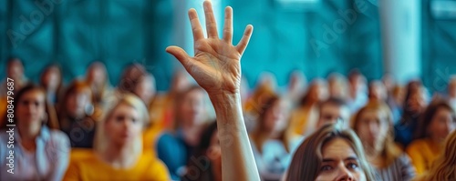 Closeup of a participants hand raising to ask a question during a leadership seminar
