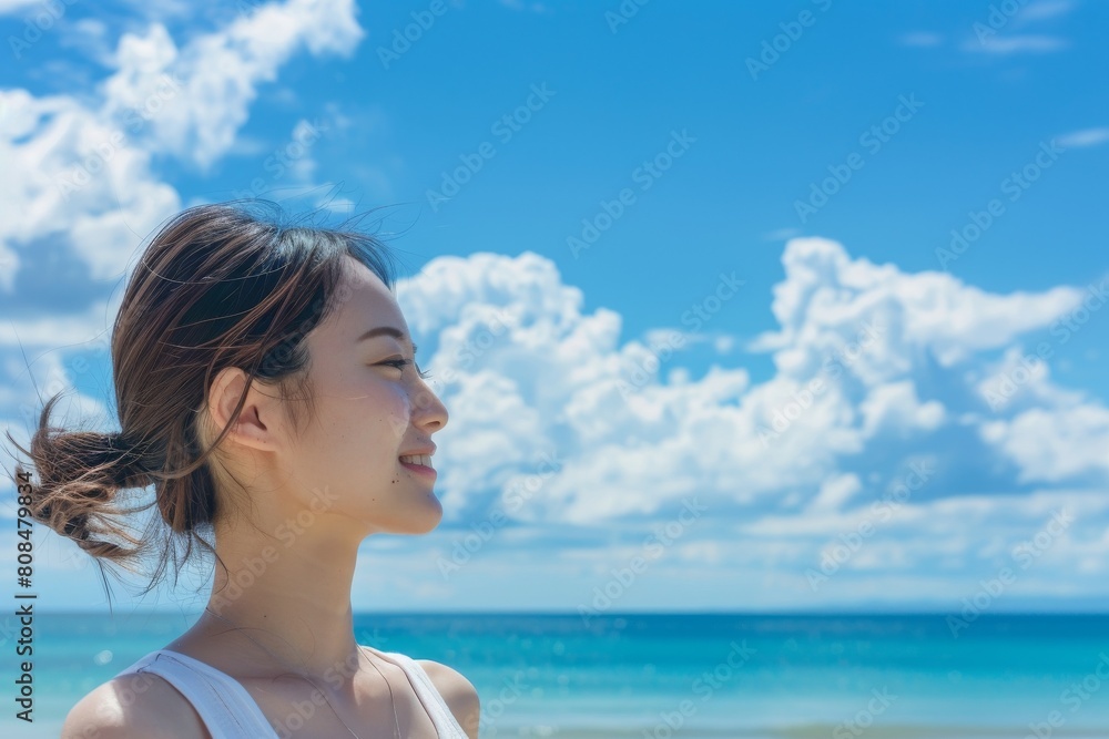 海を見ている日本人女性の横顔(ビーチ・青空・旅行・休暇) 海を見ている日本人女性の横顔(ビーチ・青空・旅行・休暇)