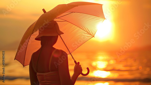 Silhouette of a woman holding an umbrella against a stunning sunset backdrop, creating a peaceful evening scene.