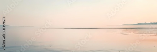 minimalist dawn over a serene body of water with a distant mountain and blue sky in the background  reflected in the calm waters