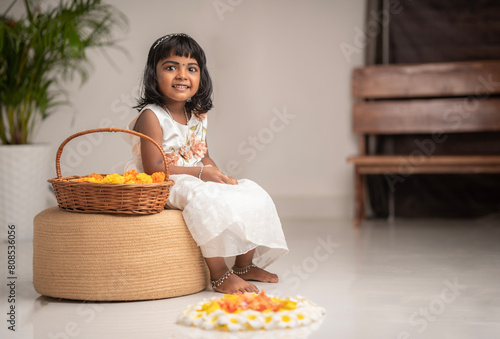 Happy Onam 2024 image Cute girl kid with Onam pookalam © sarath