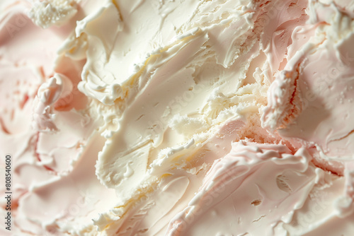 A close up of a white frosting or ice cream, with a lot of texture and detail. The frosting appears to be made of whipped cream, and it has a creamy, smooth texture