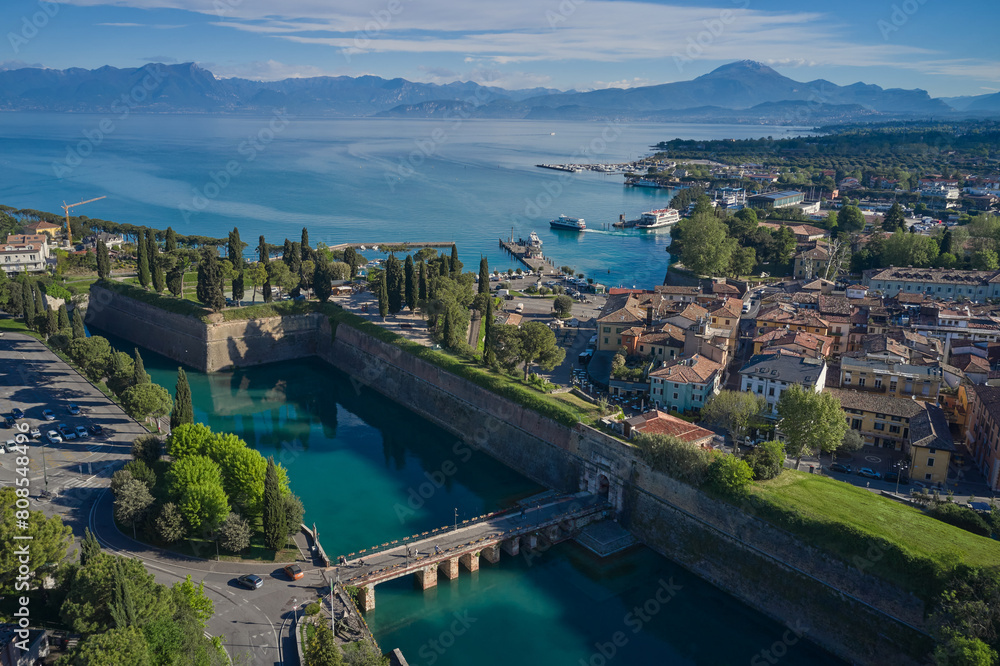 Top view of the town of Peschiera del Garda, the main gate of Porta Brescia located on the shores of Lake Garda. Resorts on Lake Garda Italy. City on the water Italy. The largest lake in Italy.