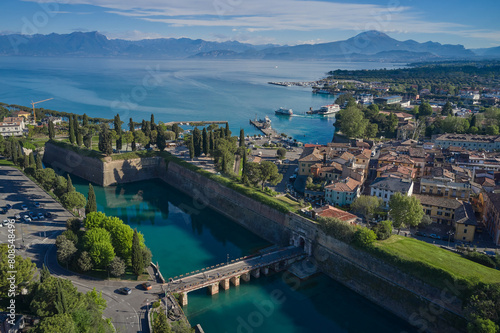 Top view of the town of Peschiera del Garda, the main gate of Porta Brescia located on the shores of Lake Garda. Resorts on Lake Garda Italy. City on the water Italy. The largest lake in Italy.
