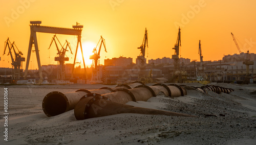 Industrial landscape:sunset over industrial areas,pipelines running through sandy desert © Mike Mareen