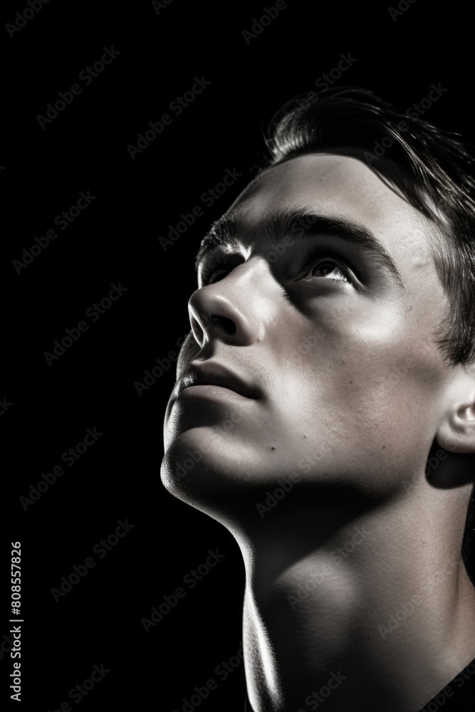 A man with a serious expression on his face. He is looking up at something. The image is in black and white A man with a serious expression on his face. He is looking up at something. The image is in black and white