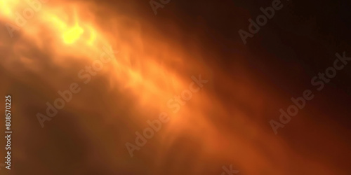 A blurred golden light with a dark background, close up of fire in the night 