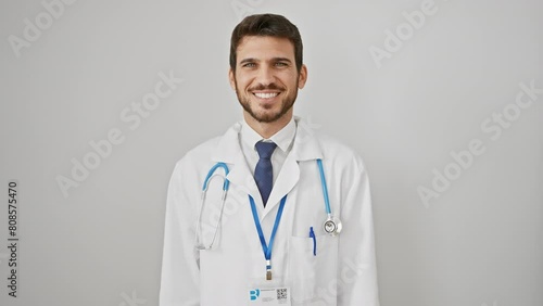 Young hispanic man sticking out tongue, a fun portrait of expressive joy! wearing stethoscope, funny expression on his face, positively radiating happiness over white, isolated background! photo