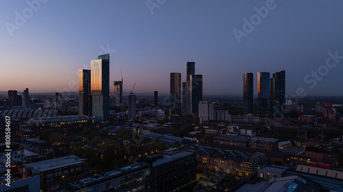 Twilight Manchester cityscape with illuminated skyscrapers
