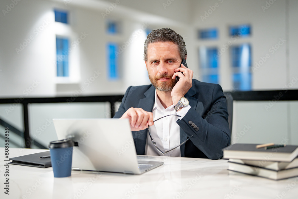 Business offices place. Businessman working with laptop in office. Business man director using laptop. Millennial manager at office workplace. Business man talking on phone at office workplace.