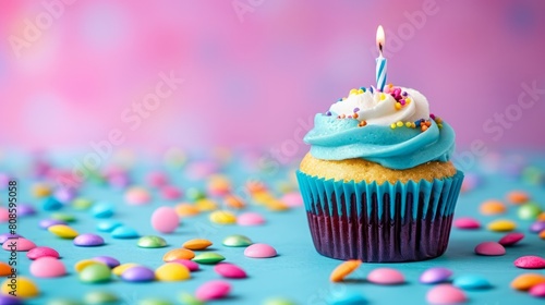 Colorful cupcake with single birthday candle