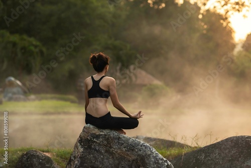 Healthy Yoga woman lifestyle balanced practicing meditate and energy yoga on the bridge in morning and sunset outdoors nature. Healthy life Concept