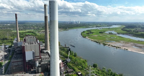 The Ruhr area is a highly industrialized region in the German state of North Rhine Westphalia. Here we see the rhine river and industrial powerplant. Aerial view.