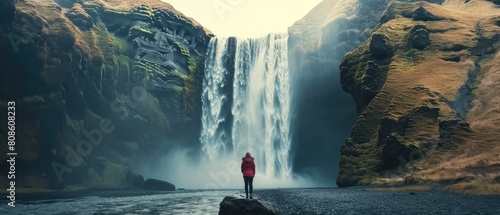 Serenity's Edge: A Woman's Reverie Overlooking Skogafoss Waterfall, Iceland photo