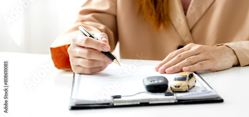 Customer hand signed the insurance contract documentation agreement for commercial auto car loan buying or vehicle rental service