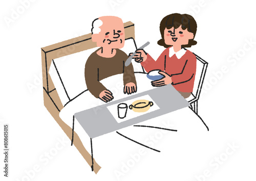 高齢男性の食事の介助をする女性
