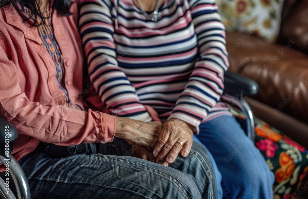 A elderly woman sitting in Wheelchair Shaking Hands With Another woman. Thank you for taking care of me A elderly woman sitting in Wheelchair Shaking Hands With Another woman. Thank you for taking care of me