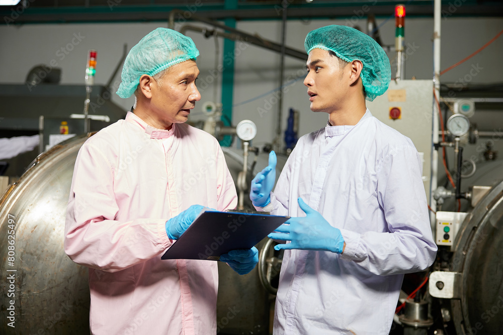 male workers meeting and talking about work or project in the beverage factory male workers meeting and talking about work or project in the beverage factory