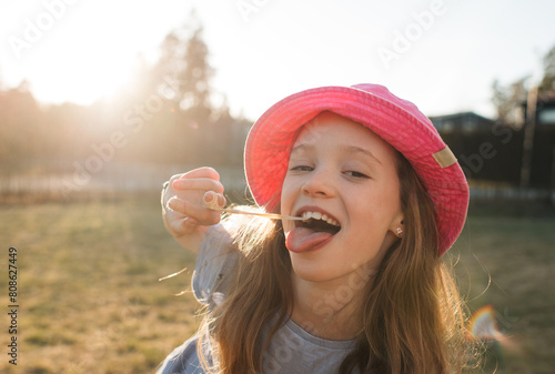 girl making faces with bubblegum on a summers day photo