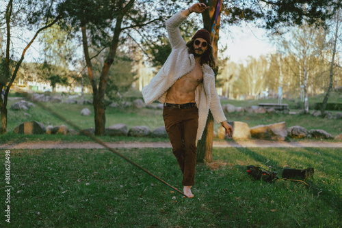 Young man practicing on a slackline photo