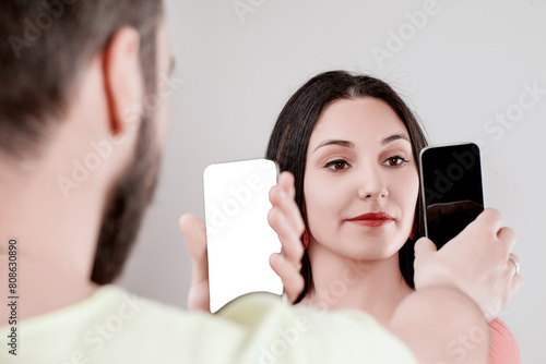 Couple shows smartphones instead of talking verbally photo
