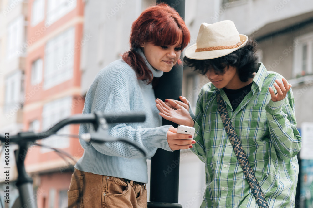 couple looking at mobile phone and arguing couple looking at mobile phone and arguing