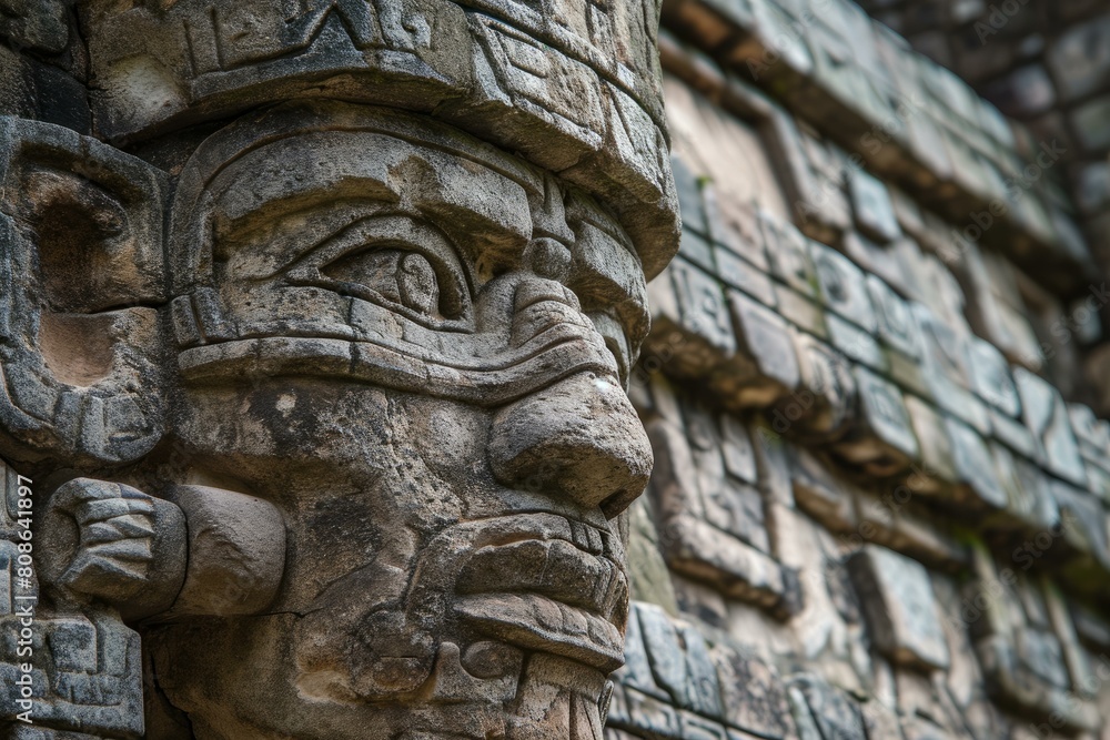 Close-up of an intricate mayan stone carving depicting a warrior or deity on an ancient temple wall Close-up of an intricate mayan stone carving depicting a warrior or deity on an ancient temple wall