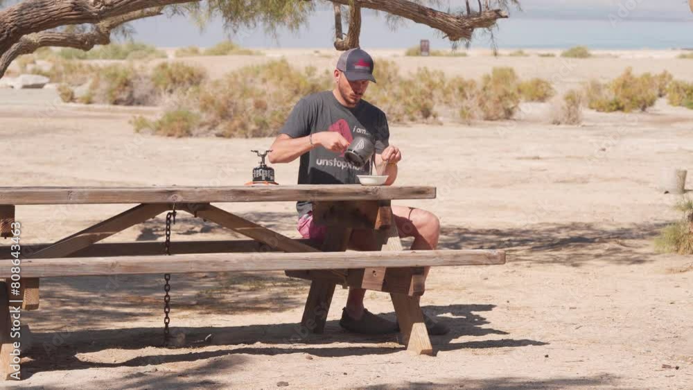 Male in his Thirties Prepare Breakfast in the Morning At Salton Sea Campground - Static Male in his Thirties Prepare Breakfast in the Morning At Salton Sea Campground - Static