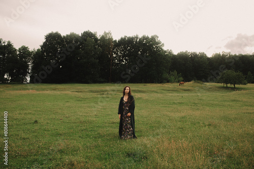 Calm woman enjoying the moment and slow life at her eco-farm. Concept green tourism, slow life, gardening, eco friendly. Part of the series