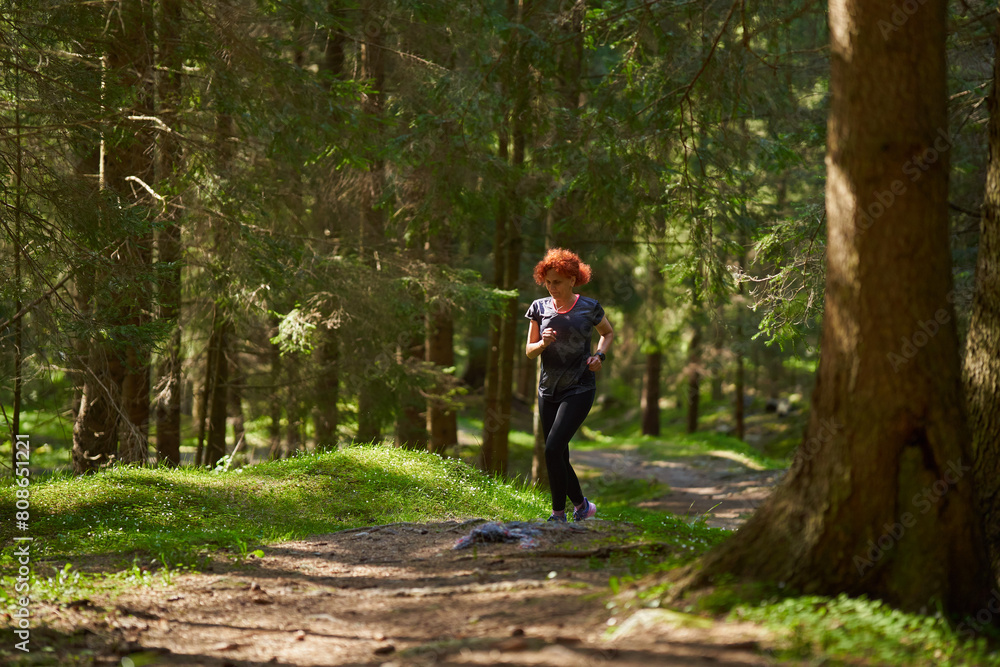 Woman trail runner in the forest Woman trail runner in the forest