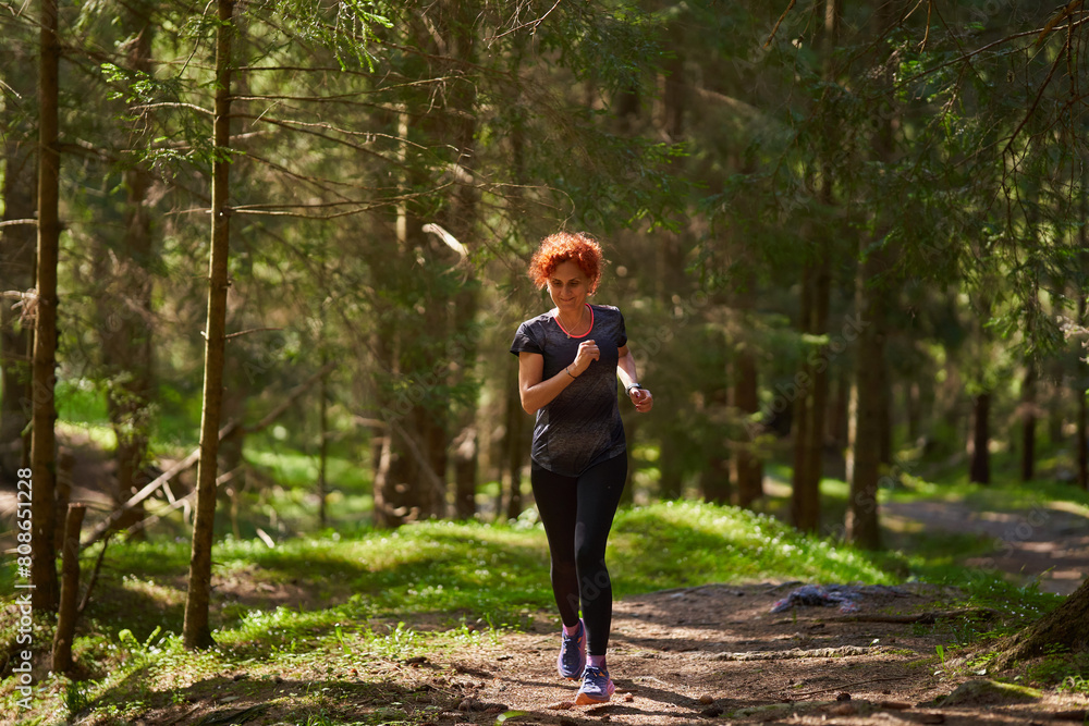 Woman trail runner in the forest Woman trail runner in the forest