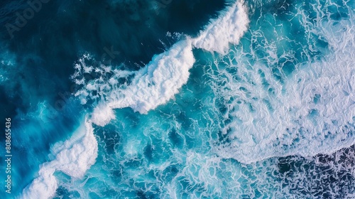 Breathtaking ocean view from above. White waves crash into the deep blue sea  creating a stunning backdrop.