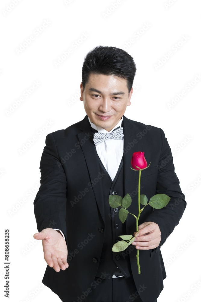 Shed middle-aged business man holding a rose Shed middle-aged business man holding a rose