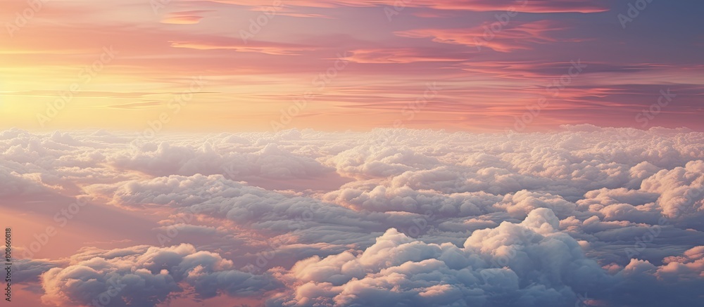 The view from the airplane window showcases a red sky at a high altitude with fluffy dense puffs of white clouds reflecting the sunset Although the image is hazy and noisy there is still ample copy s