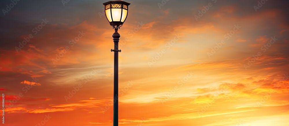 A streetlight glowing in the sunset with available copy space for adding text or images A streetlight glowing in the sunset with available copy space for adding text or images