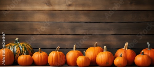 Copy space image of orange pumpkins arranged on a wooden background showcasing the essence of Halloween Thanksgiving and the autumn harvest photo