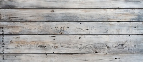 The heavily worn and peeling grey paint on the natural wood planks creates a weathered and textured background for a copy space image