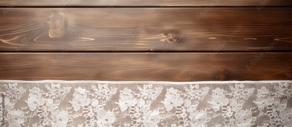 Fototapeta premium Top down view of a wooden table adorned with elegant white lace Ample space available for adding text into the image