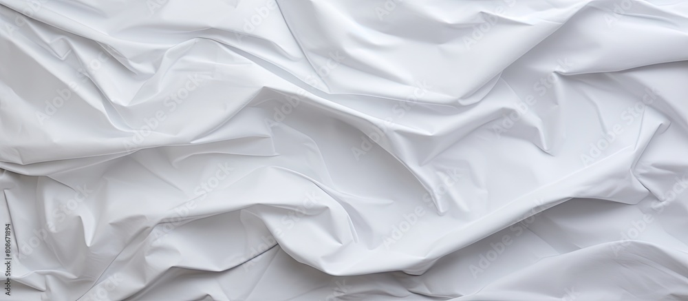 An abstract white crumpled paper background with a wrinkled and creased texture offers a unique and visually appealing copy space image An abstract white crumpled paper background with a wrinkled and creased texture offers a unique and visually appealing copy space image
