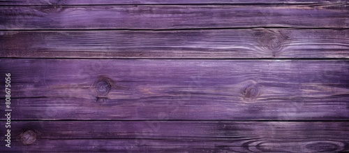 A wooden panel background with a textured purple paint design giving it a distressed appearance Suitable for copy space images