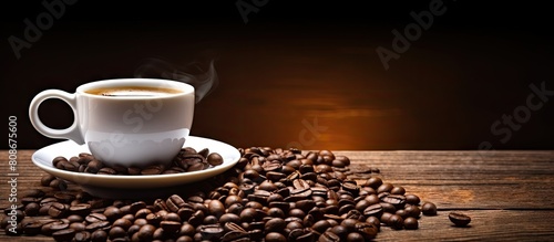 A visually appealing white coffee cup adorned with coffee beans resting on a rustic wooden background Ideal for use as a copy space image